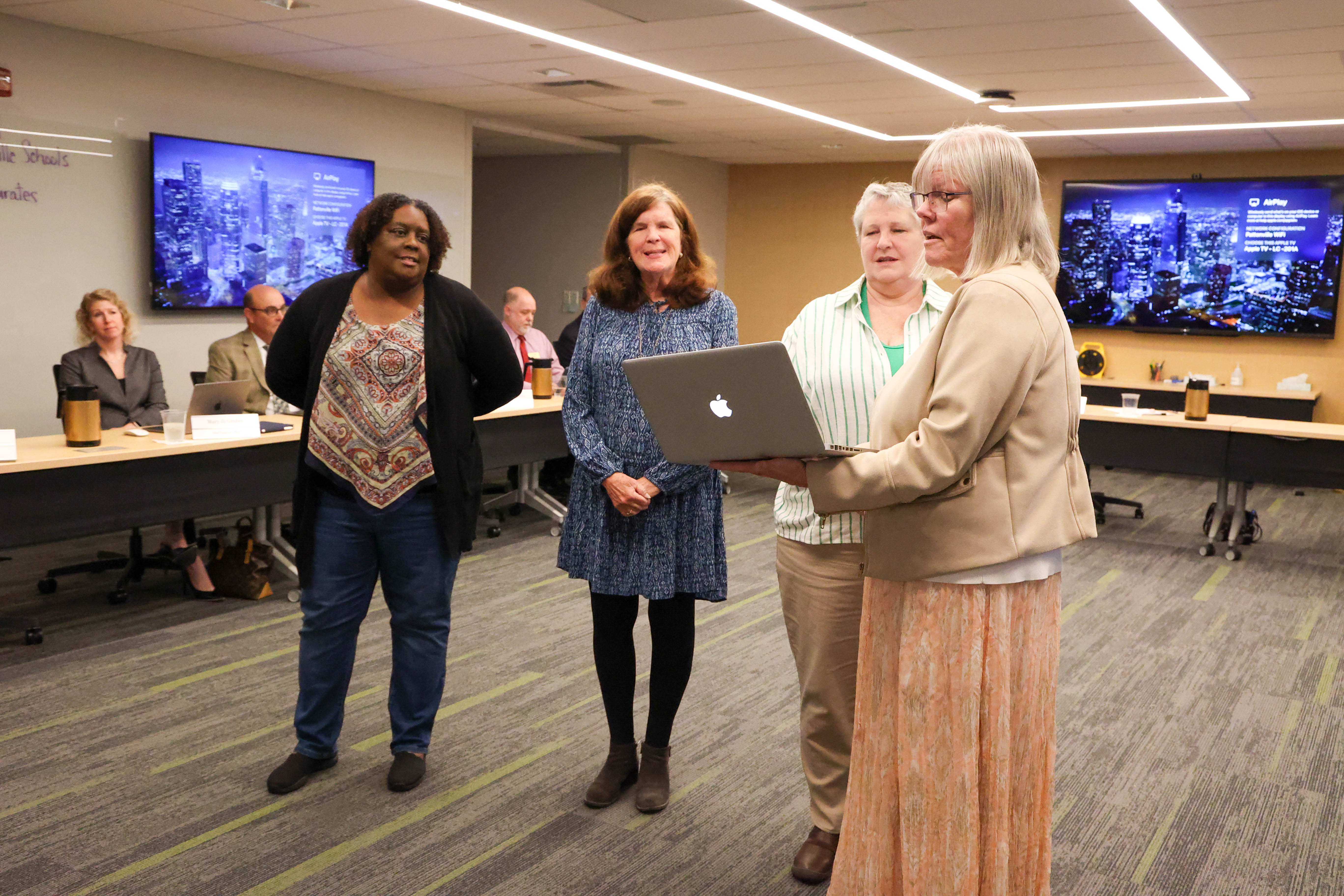 Three newly elected board members are sworn in by board president